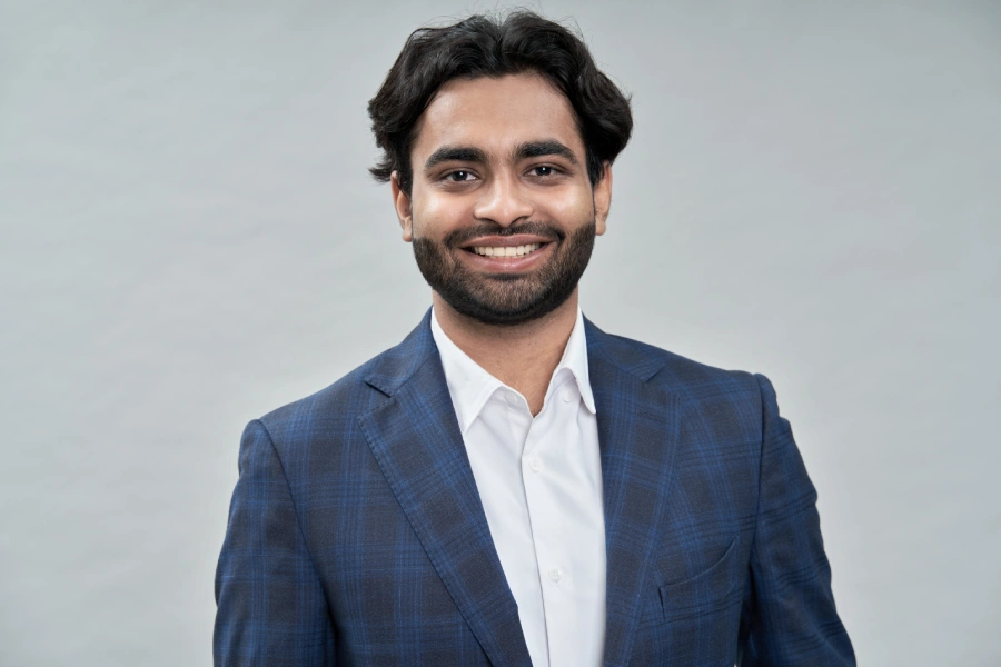 happy young indian arab business man wearing suit headshot portrait